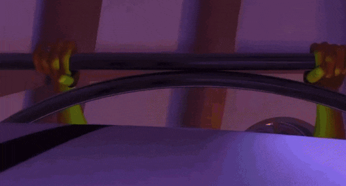 a person is holding onto a bar in a purple room .