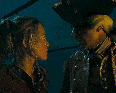 a man and a woman look at each other in a dark room