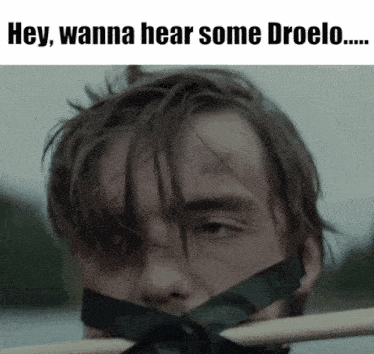 a man with a black tape around his mouth and the words hey wanna hear some droelo on the bottom