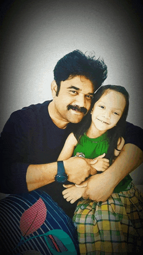a man with a mustache is hugging a little girl