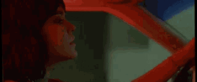 a woman with red hair is sitting in a car .