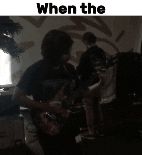 a man playing a guitar in a dark room with the words " when the " on top