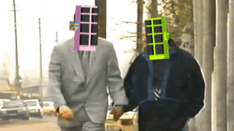 a man in a suit has a pink window on his head while walking with another man