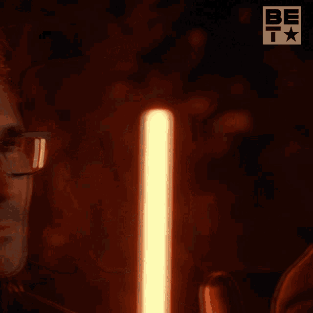 a man wearing glasses is smiling and says " don 't be ridiculous "