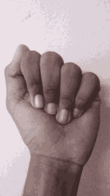 a close up of a fist with blue nails