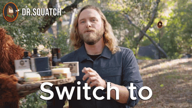a man with a beard is holding a tray of soap and the words switch to are above him