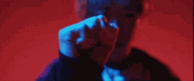 a close up of a person 's fist in a dark room .
