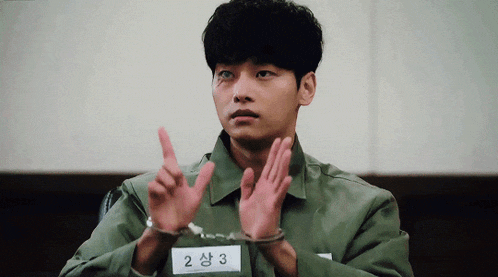 a man wearing handcuffs and a name tag that says 2 on it