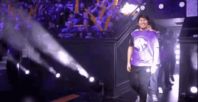 a group of people in purple jerseys are walking down a staircase .