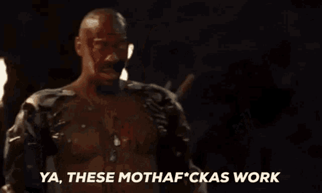a man with blood on his face is standing in front of a torch and saying `` ya , these mothaf * ckas work ''