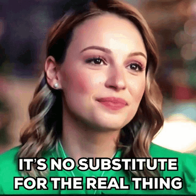a woman in a green shirt is smiling and says it 's no substitute for the real thing .