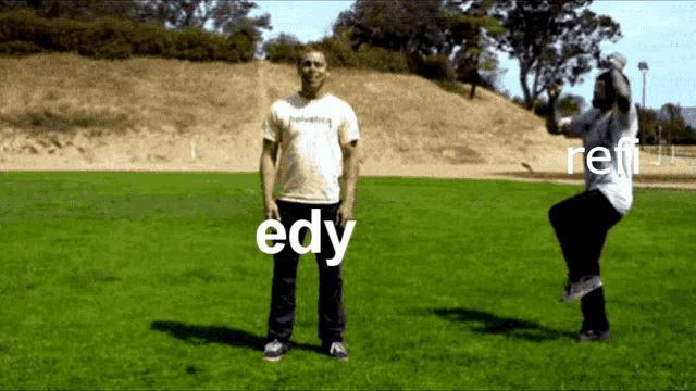 a man and a woman are standing in a grassy field with the word edy written in white