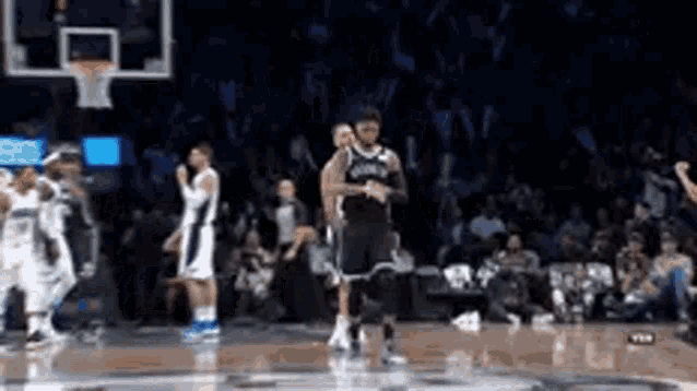 a group of basketball players are dancing on a court during a game .