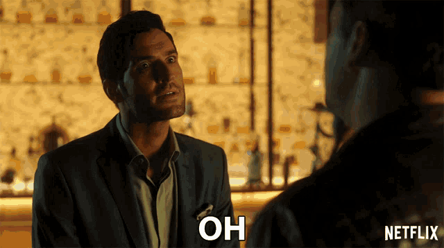 a man in a suit says " oh " in front of a netflix ad