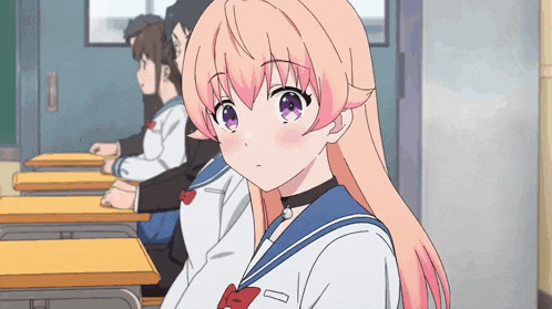 a girl with pink hair is sitting in a classroom with other students