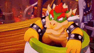 a cartoon character named bowser is sitting in a green bowl