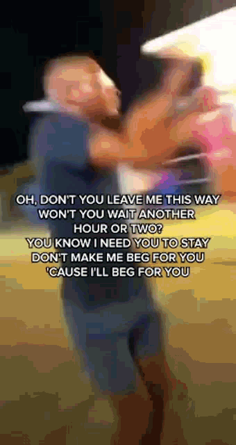 a blurry picture of a man holding another man 's arm with the words oh don t you leave me