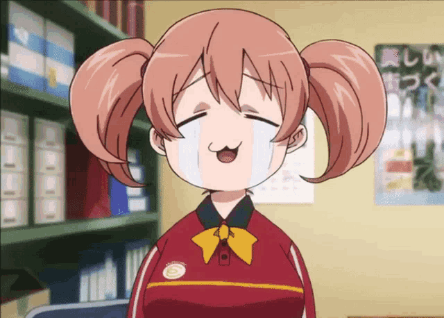 a girl with pigtails is wearing a red shirt with a yellow stripe on the sleeve