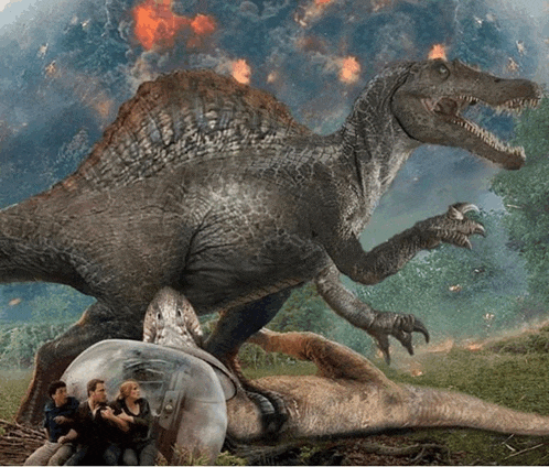 a group of people sitting in front of a dinosaur