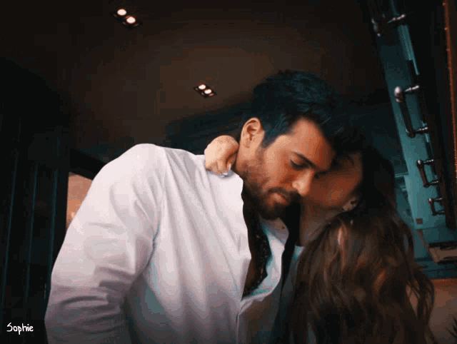 a man and a woman kissing with the word sophie on the bottom