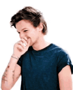 a man in a blue shirt is covering his mouth with his hand