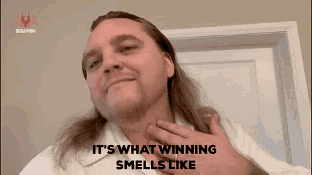 a man with long hair and a white shirt says " it 's what winning smells like "