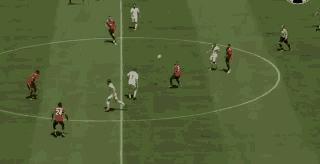 a group of soccer players are playing a game of soccer on a field .
