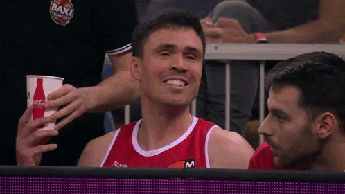 a man in a red jersey with the word baxi on the front