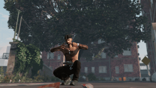 a man without a shirt is squatting down in front of a building