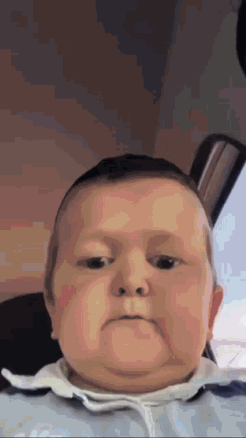 a baby making a funny face while sitting in a car seat