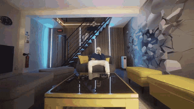 a man wearing a mask sits on a couch in a room