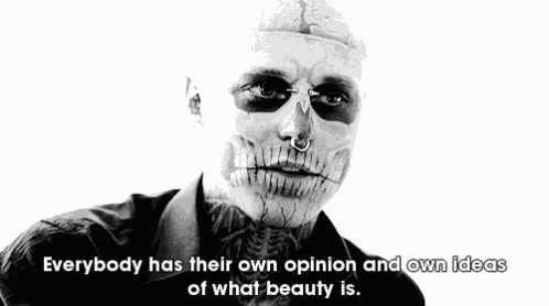 a black and white photo of a man with a skull painted on his face