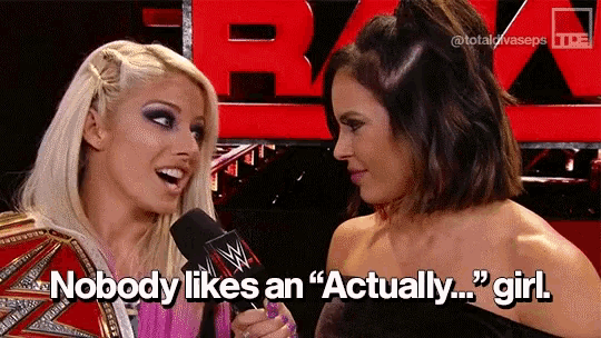 two women are talking in front of a sign that says " nobody likes an "