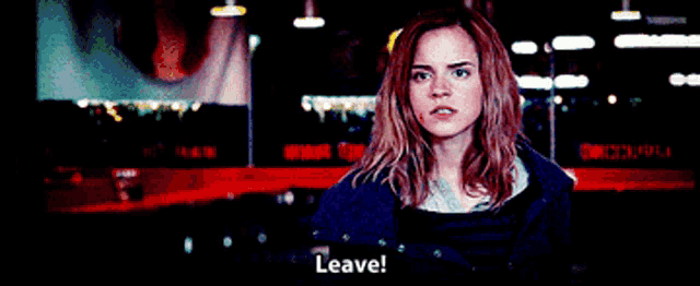 a woman is standing in front of a sign that says " leave "