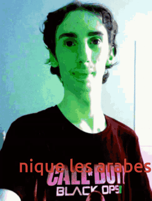 a young man wearing a call of duty black ops shirt