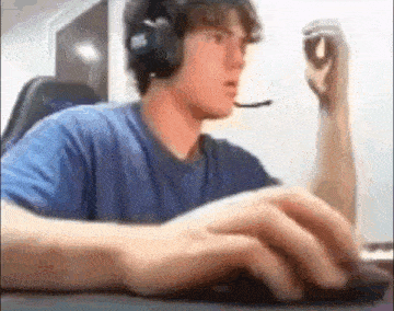 a man wearing headphones and a microphone is playing a video game on a computer .