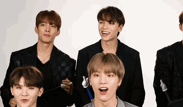 a group of young men are posing for a picture and one of them is smiling