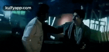 a man and a woman are dancing together in a dark room .