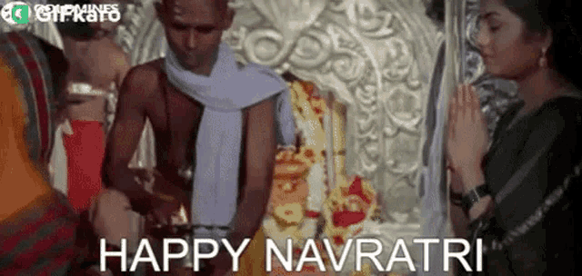 a man and woman are praying in front of a statue and the words happy navratri are written on the bottom