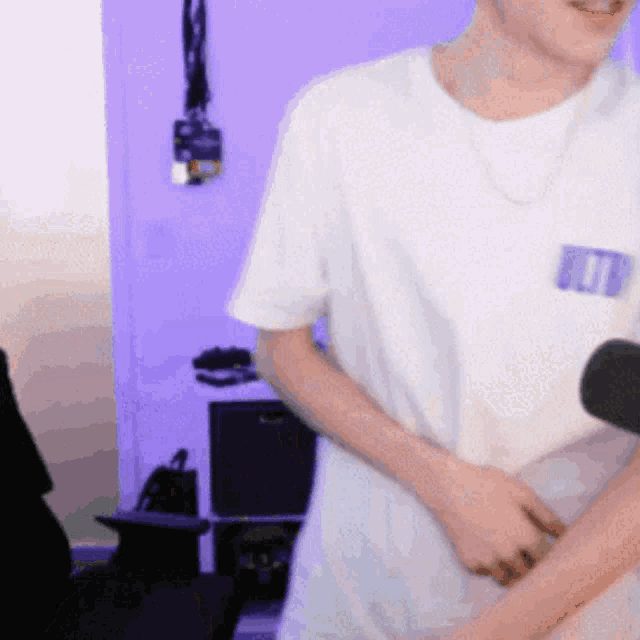 a man wearing a white t-shirt with a blue tag that says ' id ' on it