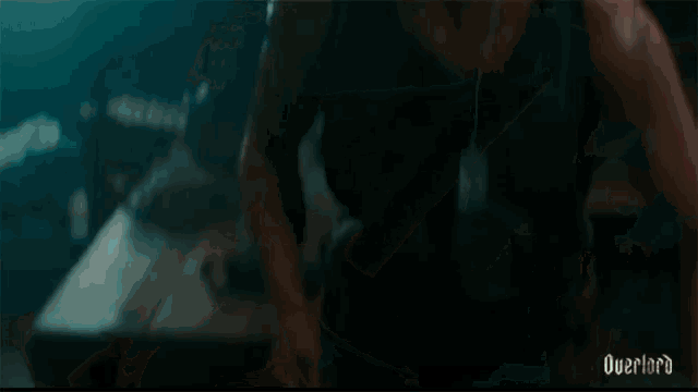 a close up of a person holding a knife with the word overlord written on the bottom