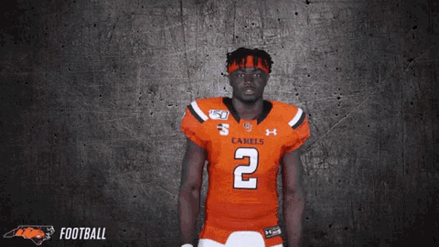 a football player wearing an orange jersey with the number 2
