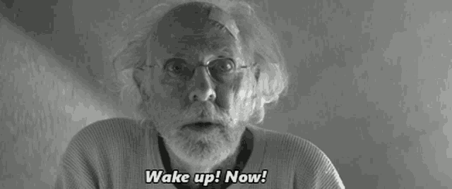 a man with glasses and a bandage on his head says " wake up now "