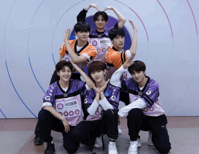 a group of young men are posing for a picture and one of them has a name tag that says ' a ' on it