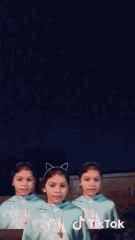 a girl in a party hat is dancing in front of a tiktok logo