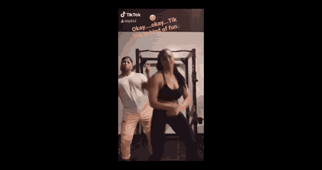 a man and a woman are doing squats in front of a sign that says tik tok