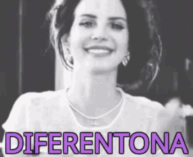 a woman is smiling in a black and white photo with the words diferentona written in purple letters .