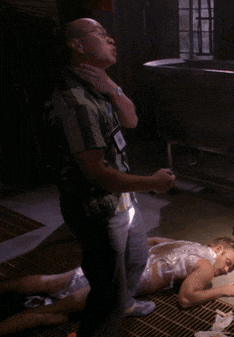 a man with a name tag on his neck stands next to a woman covered in tape