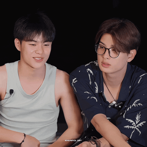 two young men are sitting next to each other and the gif is titled khunpol