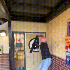 a man is standing in front of a avengers logo